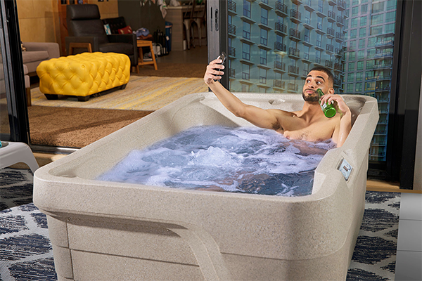 Man taking a selfie in a mini hot tub