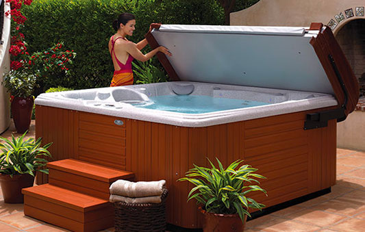 Woman removing copper from a hot tub on a deck