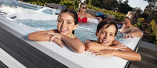 Family hanging out in a swim spa